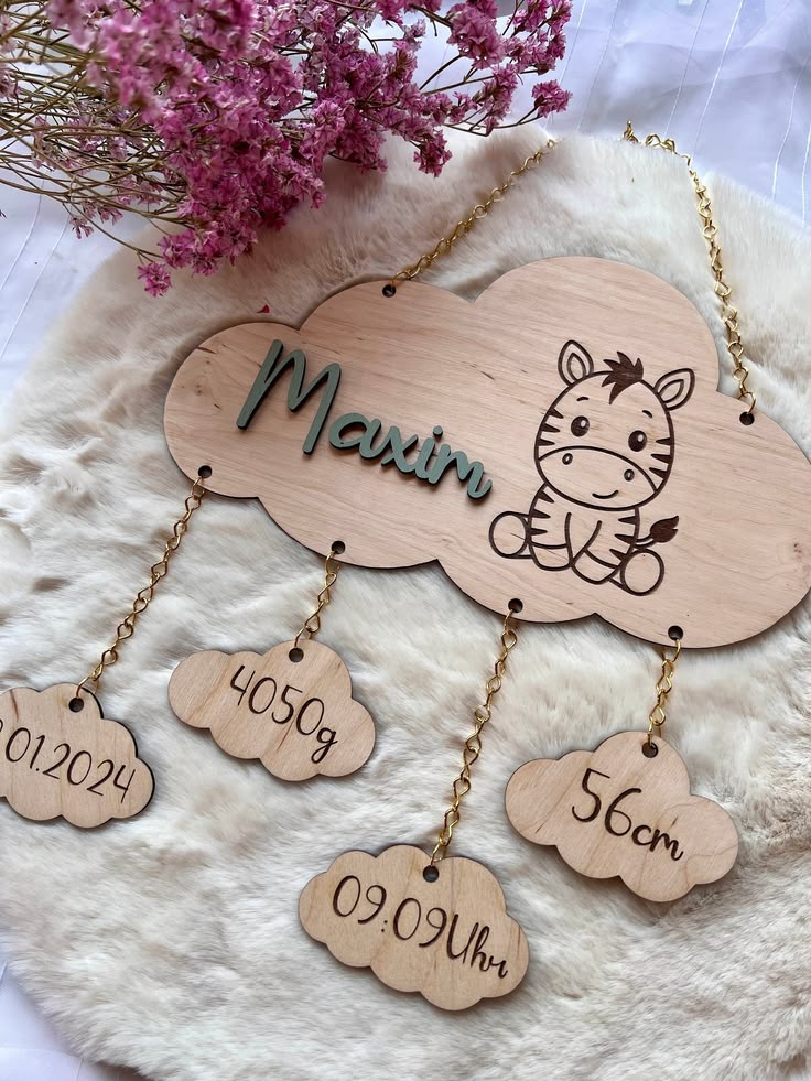 A budget-friendly nursery with framed printable art, a handmade garland, styled shelves, and a felt mobile in soft neutral tones